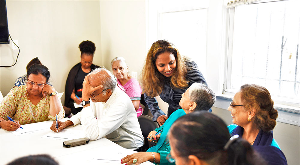 a person helping seniors fill out forms